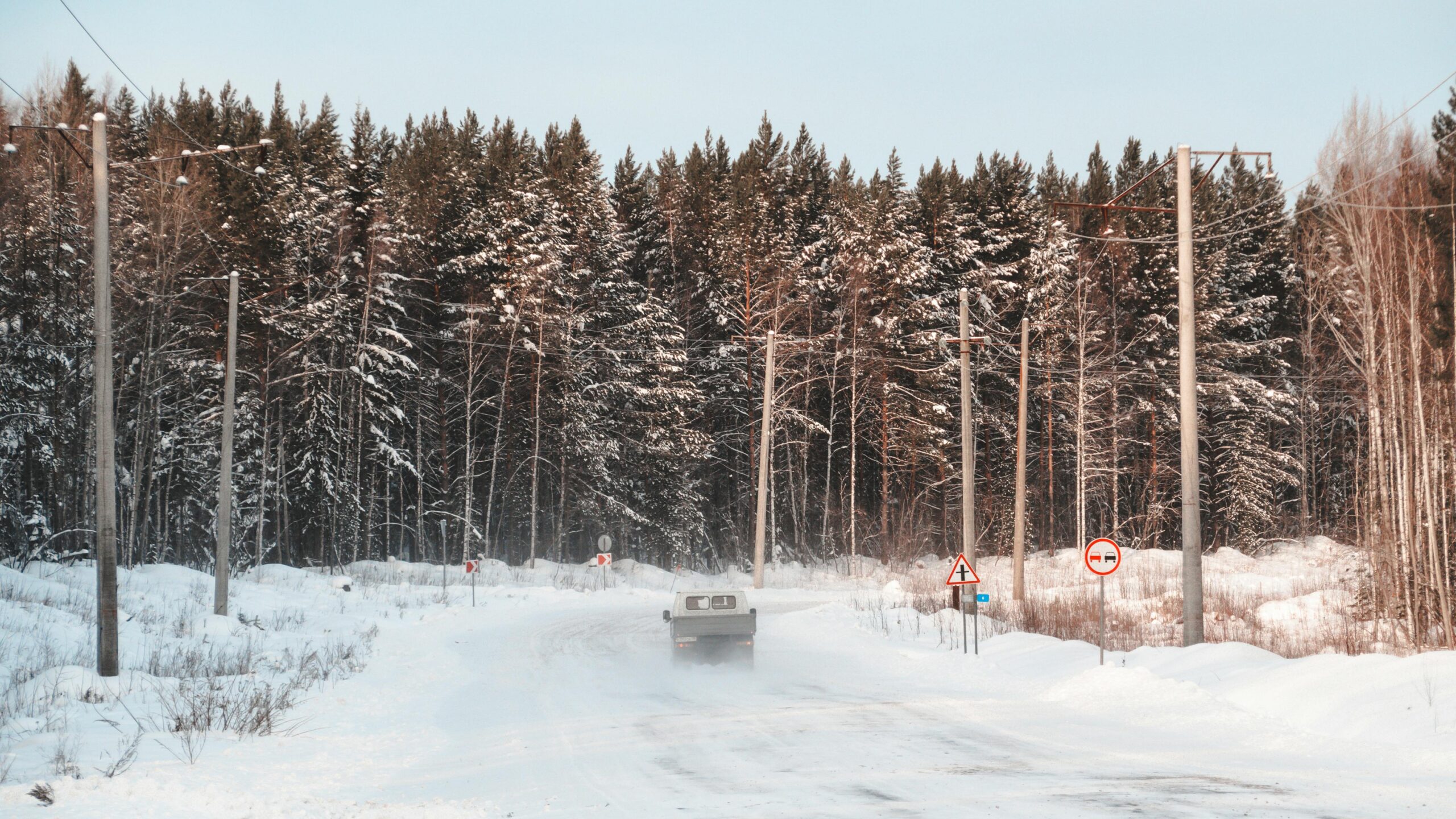 Winter road through snowy forest in northern Russia, route to Murmansk