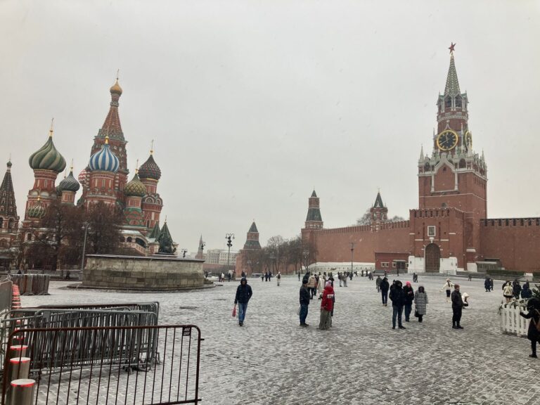 Red Square under falling snow with St Basil's Cathedral and the Spasskaya Tower