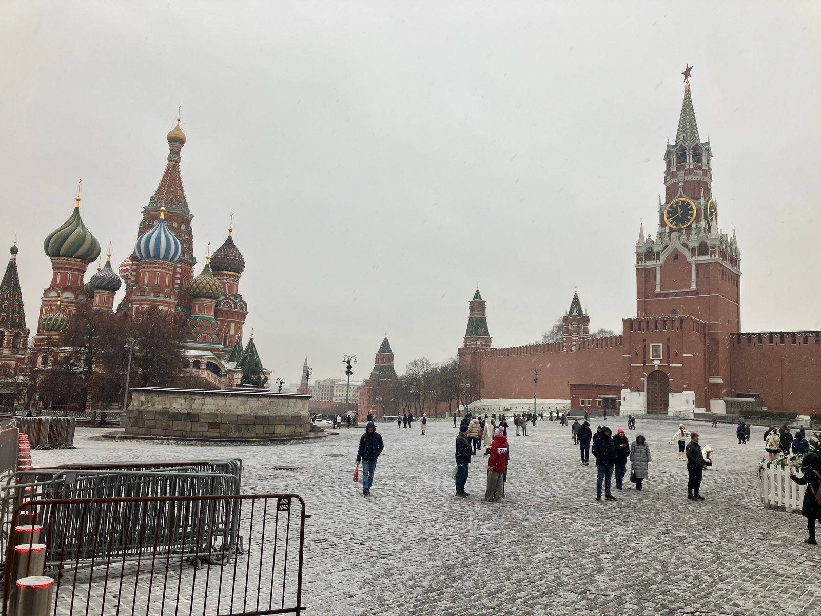 Red Square under falling snow with St Basil's Cathedral and the Spasskaya Tower