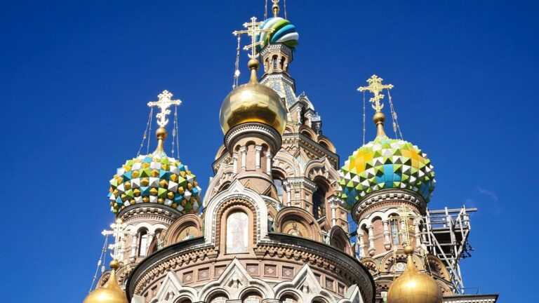 The enamelled and gilded domes of the Church of the Savior on Spilled Blood against a deep blue sky