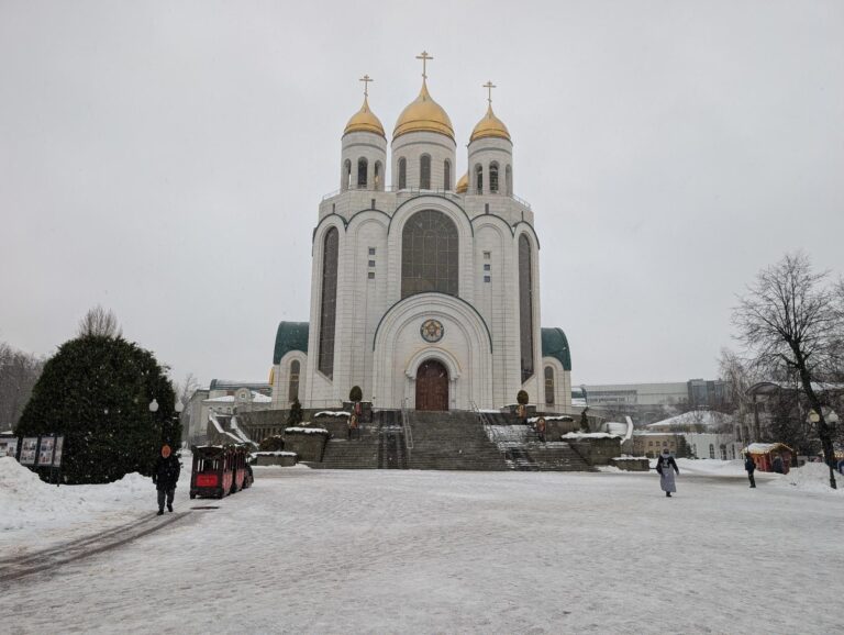 The white Cathedral of Christ the Saviour with golden domes on Victory Square in Kaliningrad during a snowfall