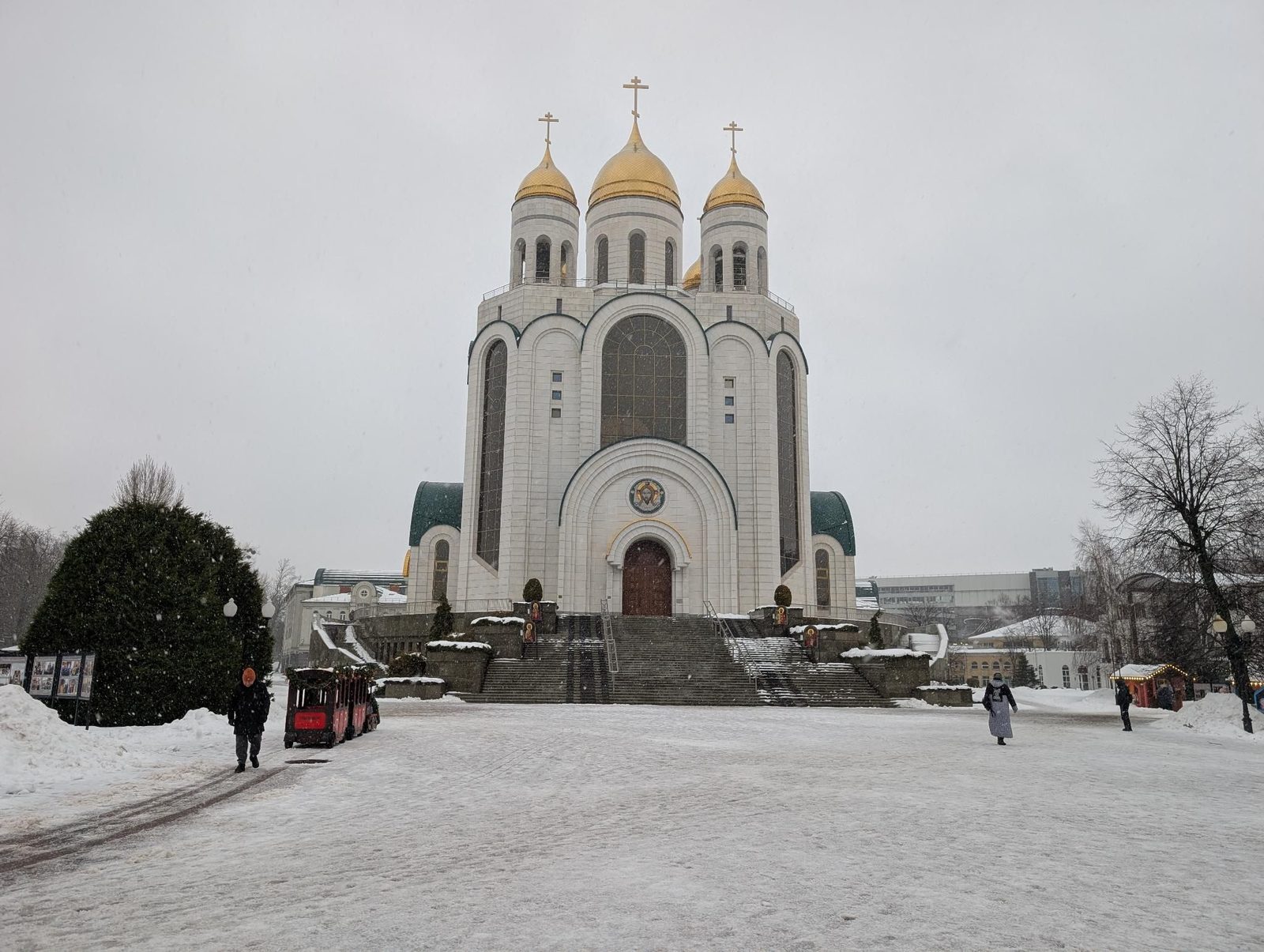 The white Cathedral of Christ the Saviour with golden domes on Victory Square in Kaliningrad during a snowfall