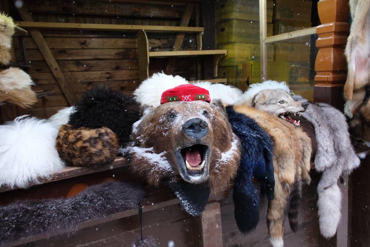 Fur hats and sheepskins on display at a stall in the Izmailovo market