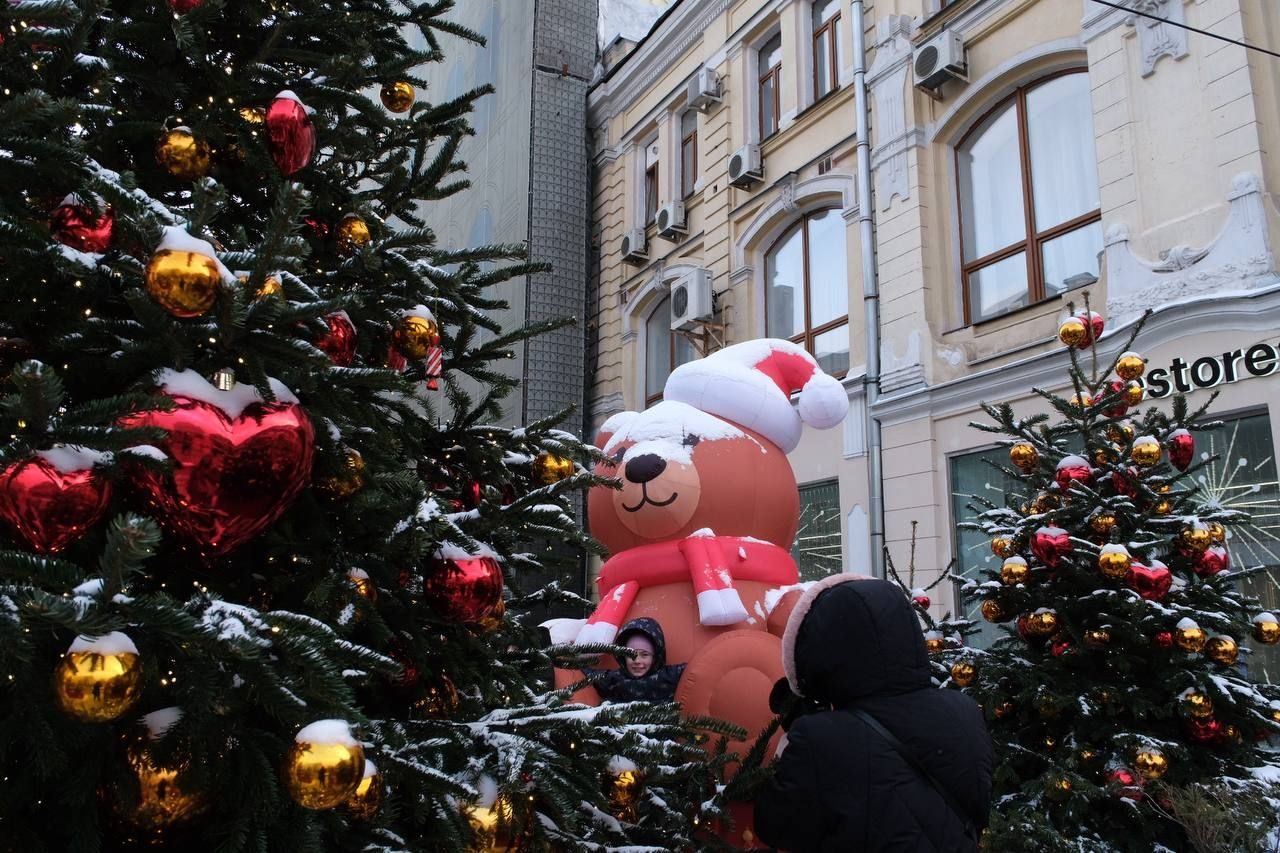 A decorated New Year tree with red and gold baubles on a Moscow street