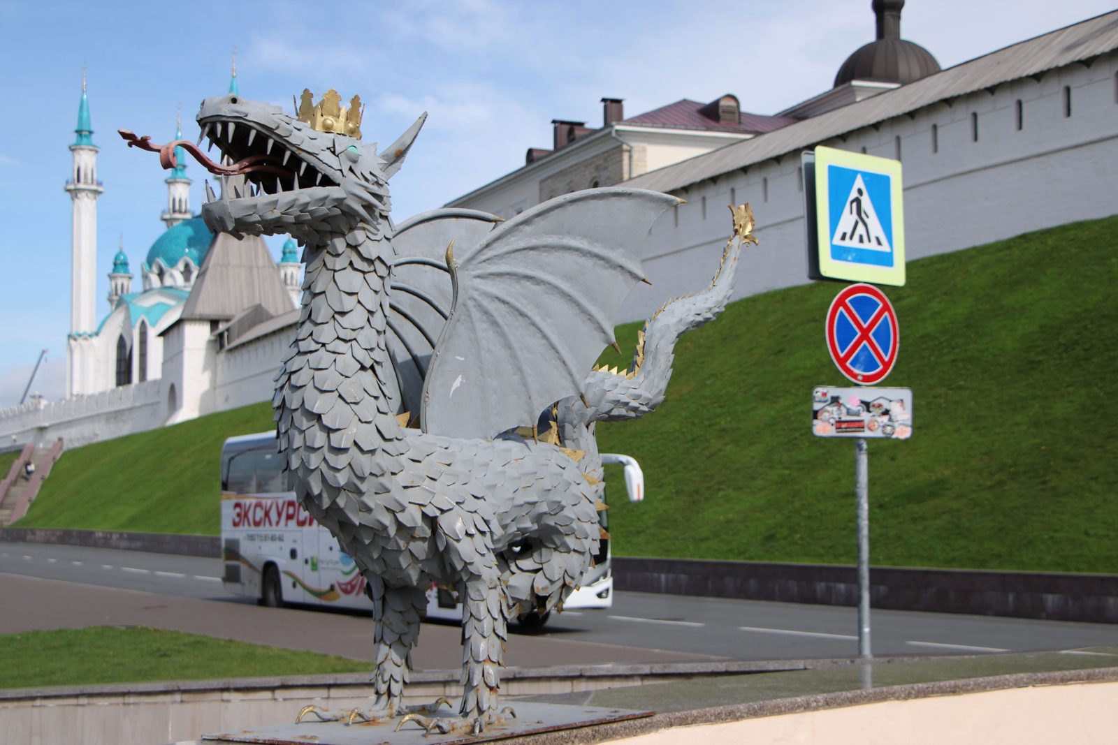 The Zilant dragon statue in front of the white walls of the Kazan Kremlin and the Kul Sharif mosque